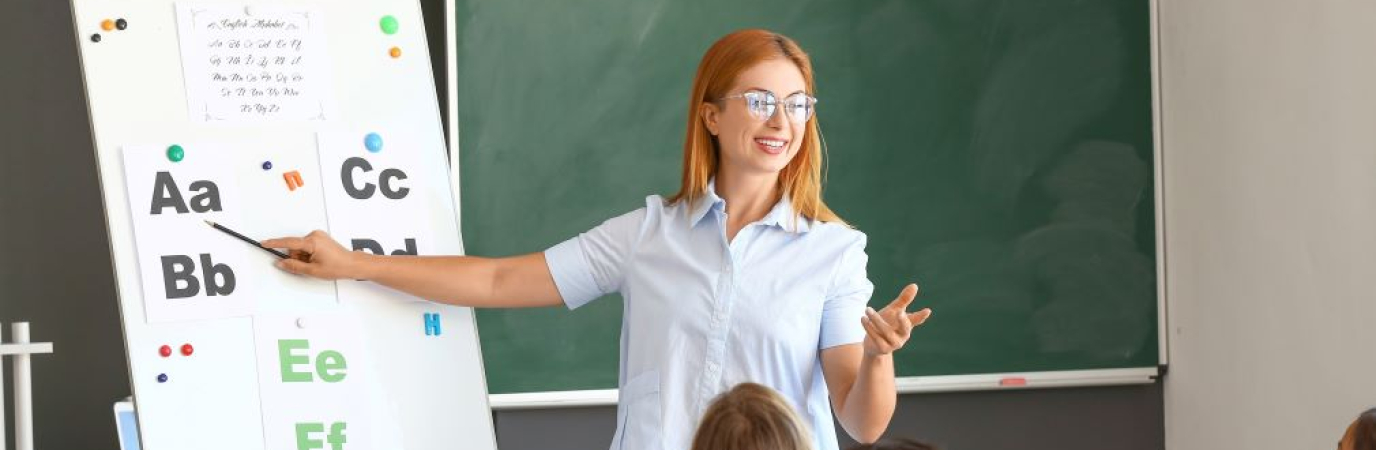 Teacher standing before group of young children