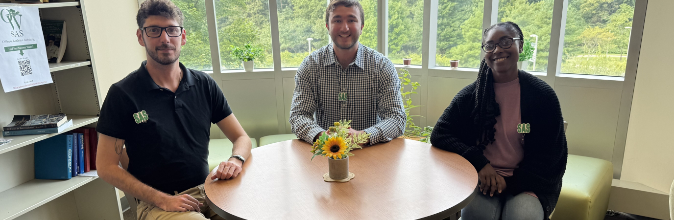 Three academic advisors sitting at table