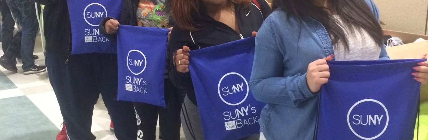 Students hold comfort kit bags