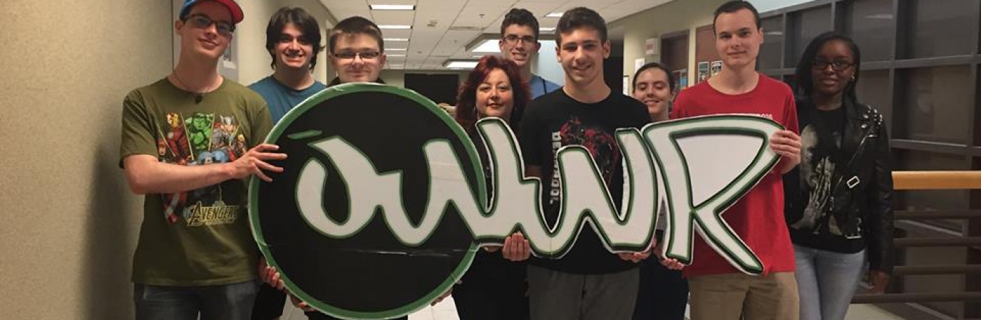 Participants in Project Stewardship holding OWWR logo cutout
