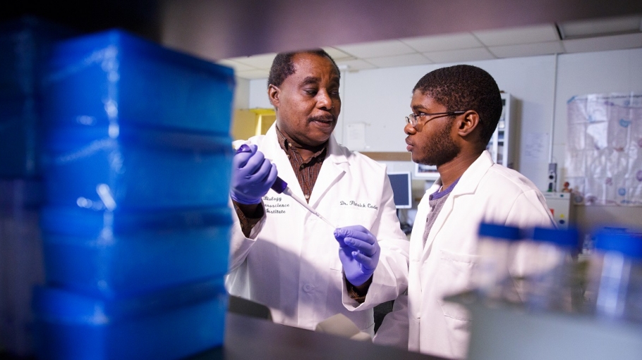 Dr. Cadet in research lab with student