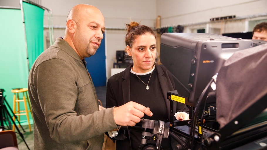 Instructor and student with camera in studio