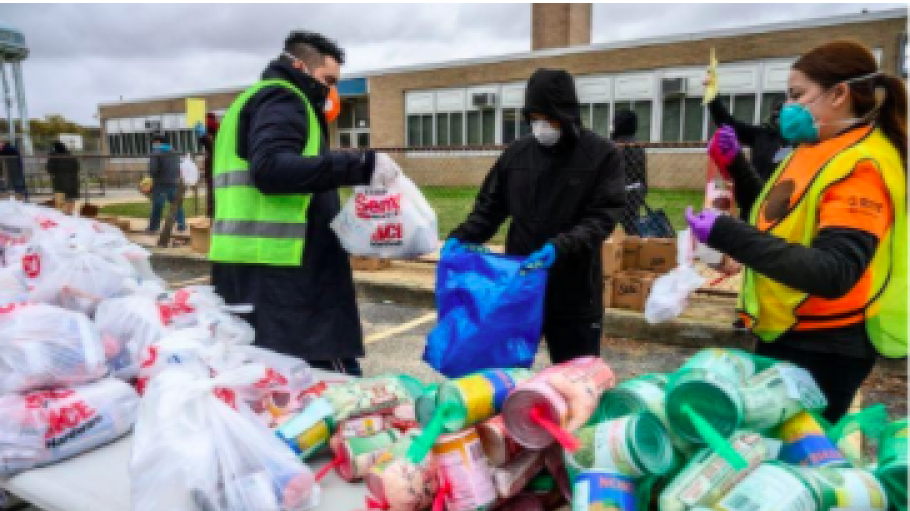 Three students bagging up donations