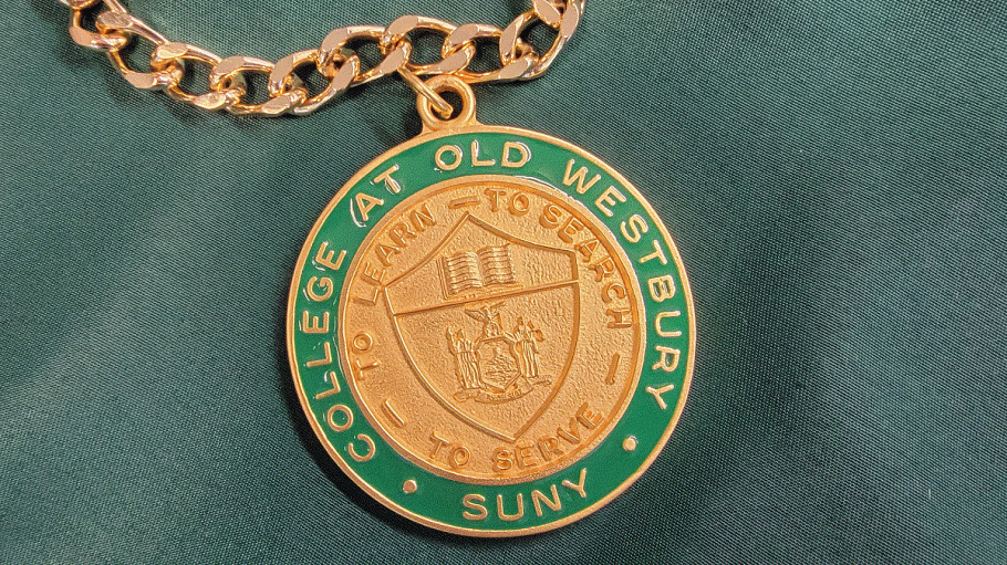 Green and gold president's medal on gold chain