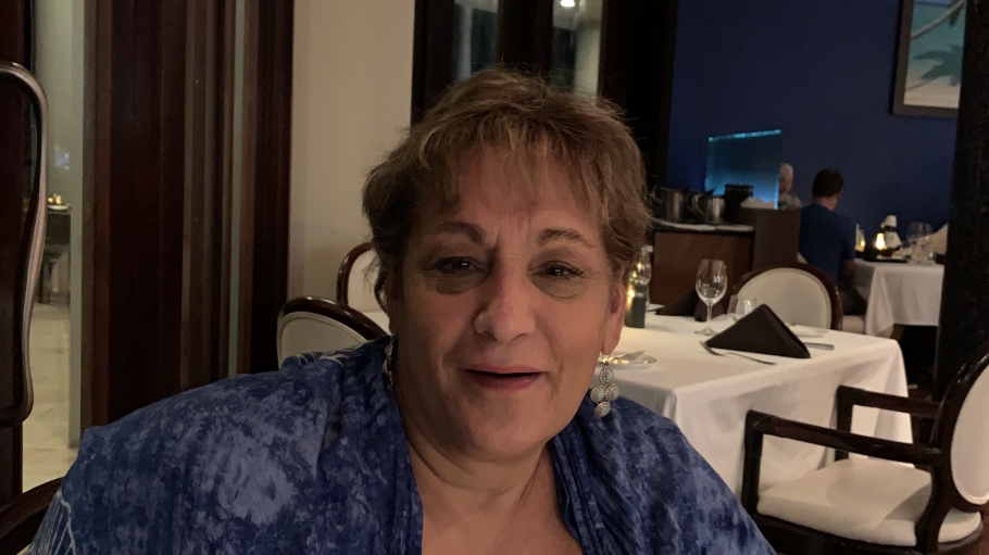 Headshot of Lydia Karyotakis in a white shirt and blue sweater