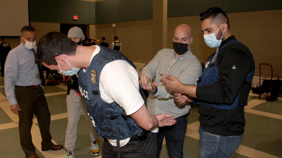 IRS Agent shows a student how to apply handcuffs during Adrian Project