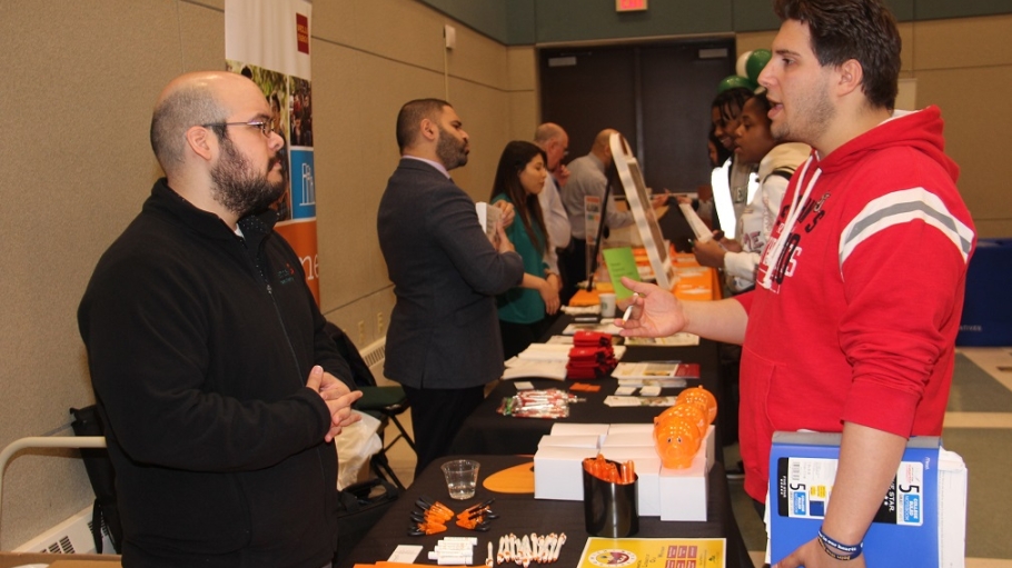 Student speaks with financial professional during the 2019 Financial Literacy Fair