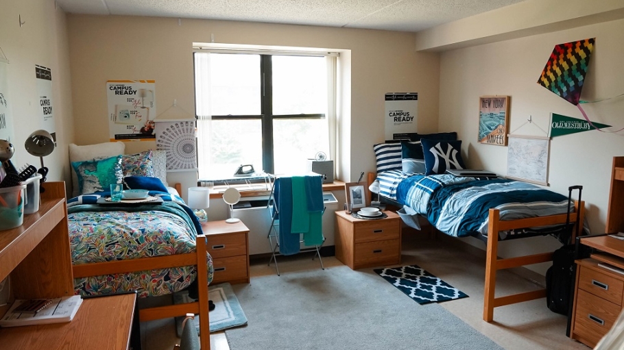 Empty residence hall room with decorations and bedding