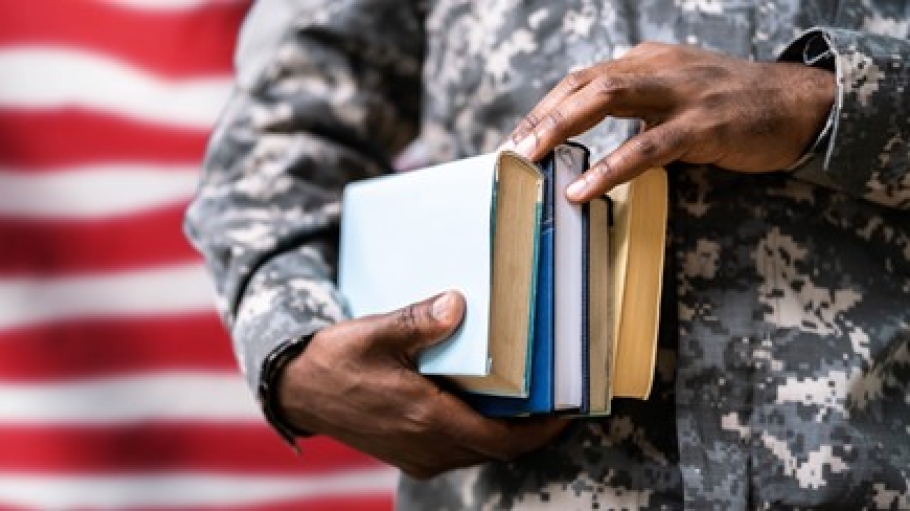 American flag in background with profile of student holding books