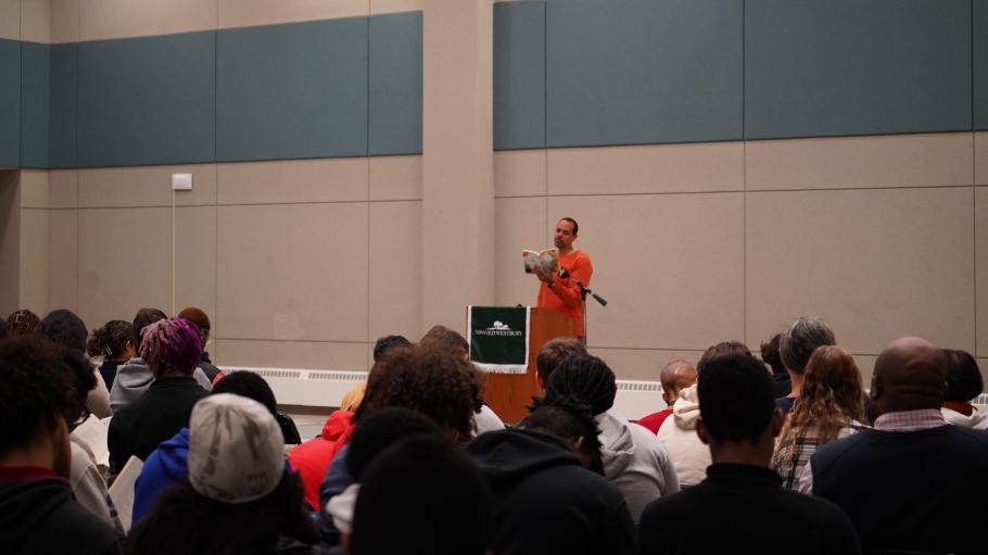 Acclaimed poet Ross Gay speaking to students during the Common Reader Poetry Reading event  