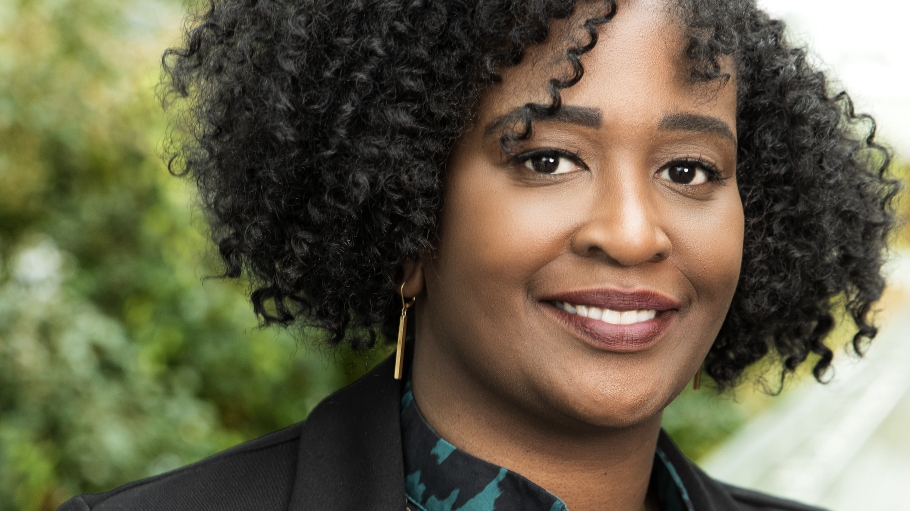Headshot of Executive Director, Teseria Ezzell, with a tree behind her