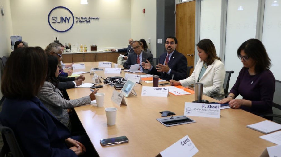 SUNY Chancellor King leads discussion among eight people around a table