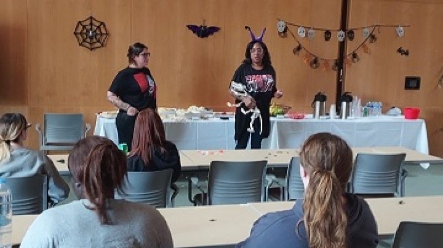 Photo of Professors Dr. Williams and Dr. Lee speaking to Students at Horror Conference