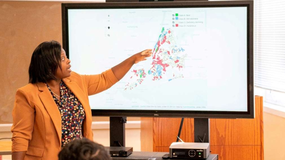 Professor showing healthcare data on a large screen