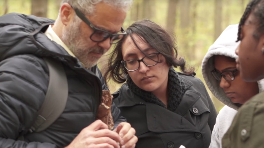 Fernando Nieto in the field with three students