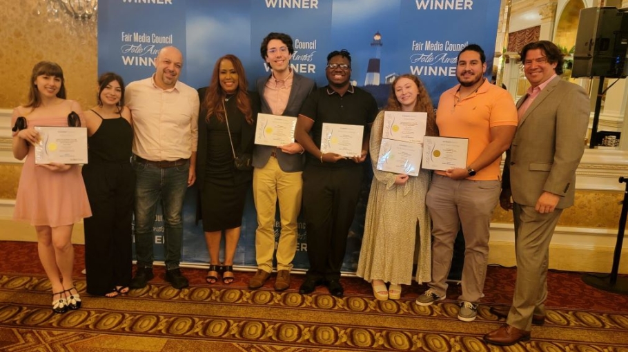 Nine students and faculty holding award certificates