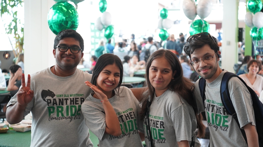 Four international students wearing panther pride shirts