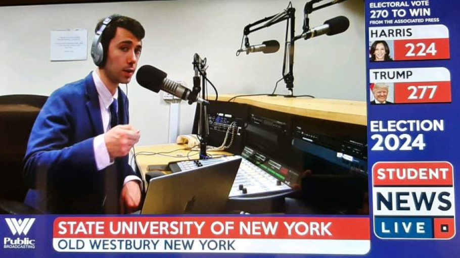 Student in a radio studio wearing headphones and speaking into a microphone
