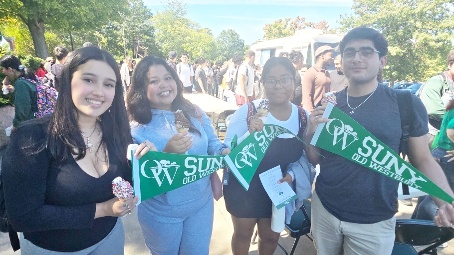 Four freshman students holding OW banners