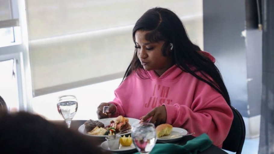 Young black woman dines on lobster