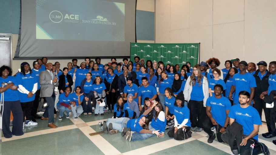 Group photo of 50 people wearing blue tee shirts