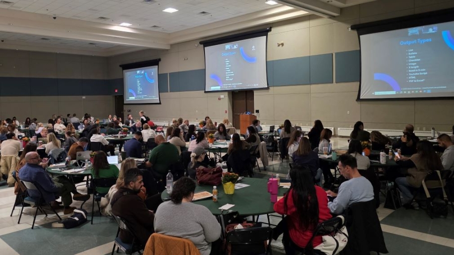 Large group of people sitting at round tables in a conference room