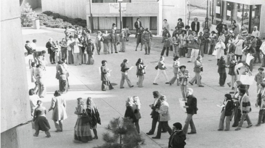 Black-and-white photo of people protesting on a plaza