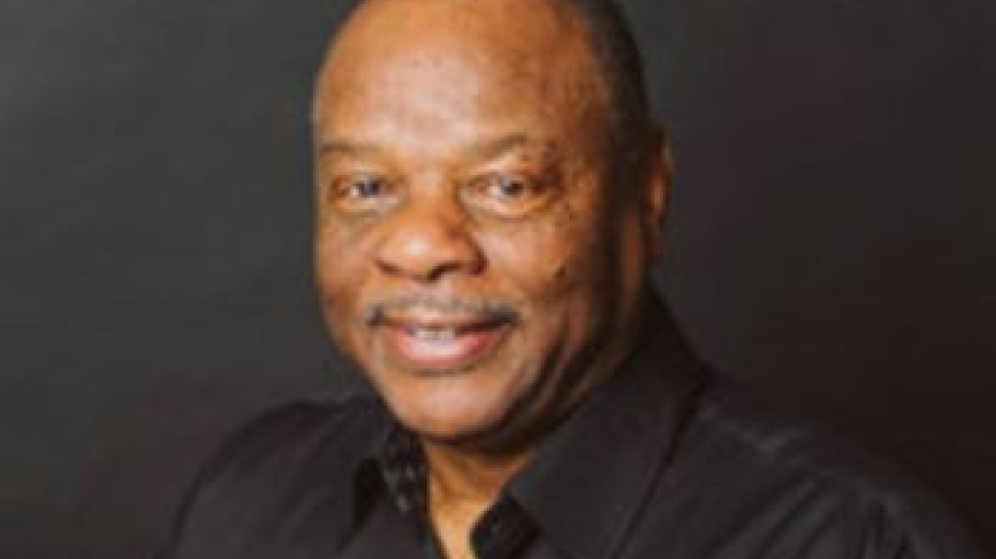 African American man in black button-down shirt featuring two white rectangles
