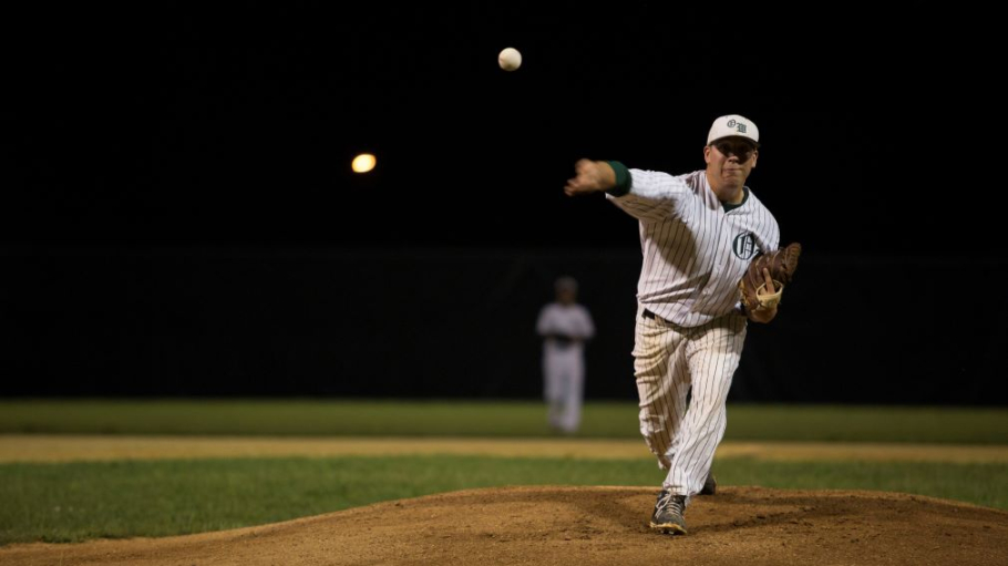 Young man in uniform pitching from a baseball mound