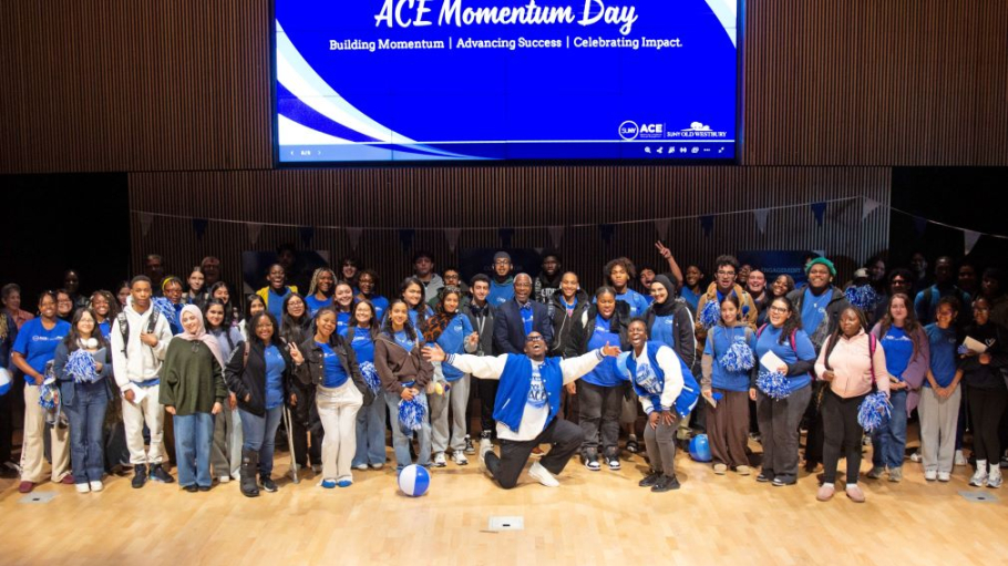 Group photo of a large, diverse group of students, most wearing blue ACE tee shirts, 