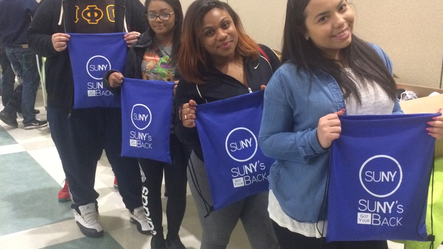 Students hold comfort kit bags