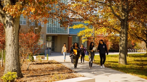 Students walking in front of NAB on a fall day