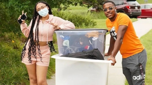 Two students with a moving cart