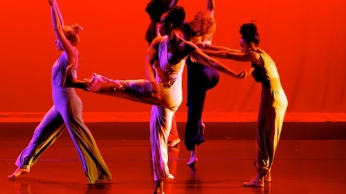 Five dancers performing on stage