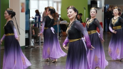 Six dancers in purple gowns