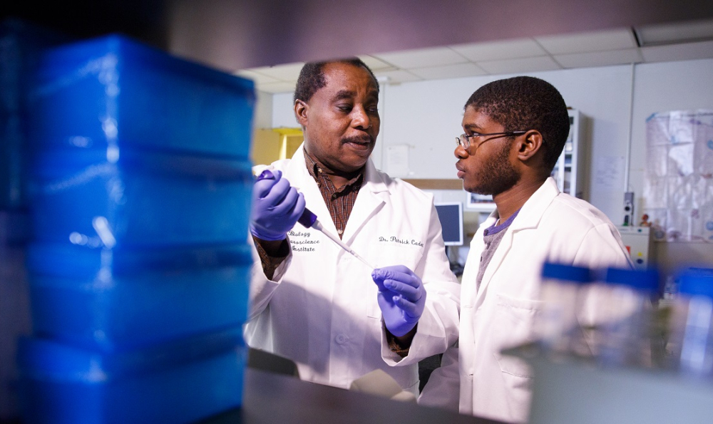 Dr. Cadet in research lab with student
