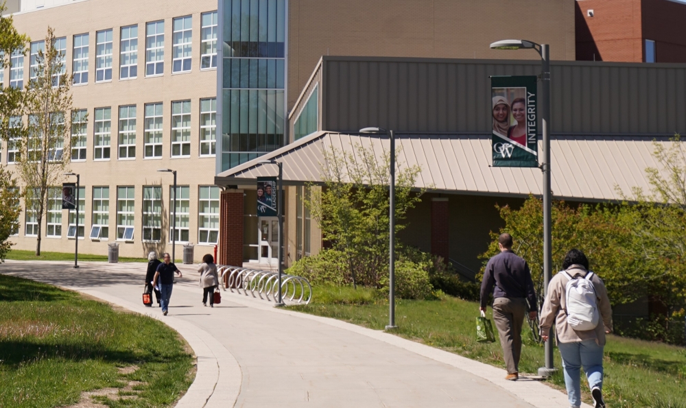 Students walk the path to the NAB building