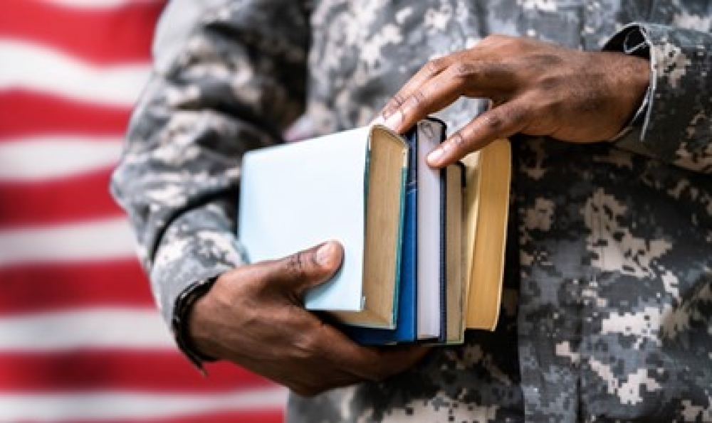American flag in background with profile of student holding books