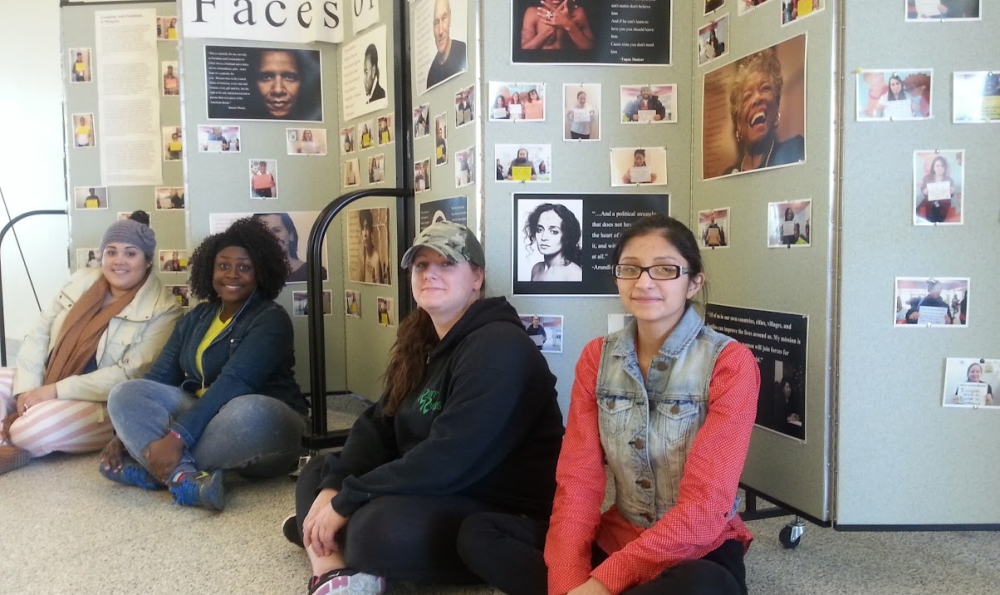 students sit in front of project board