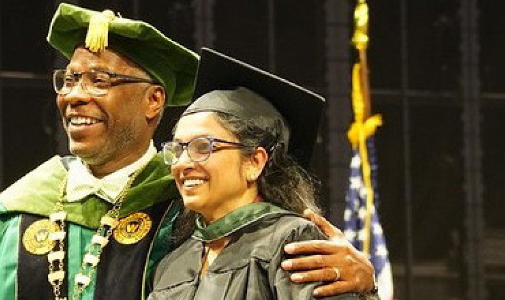 Dr Sams and graduating student smiling