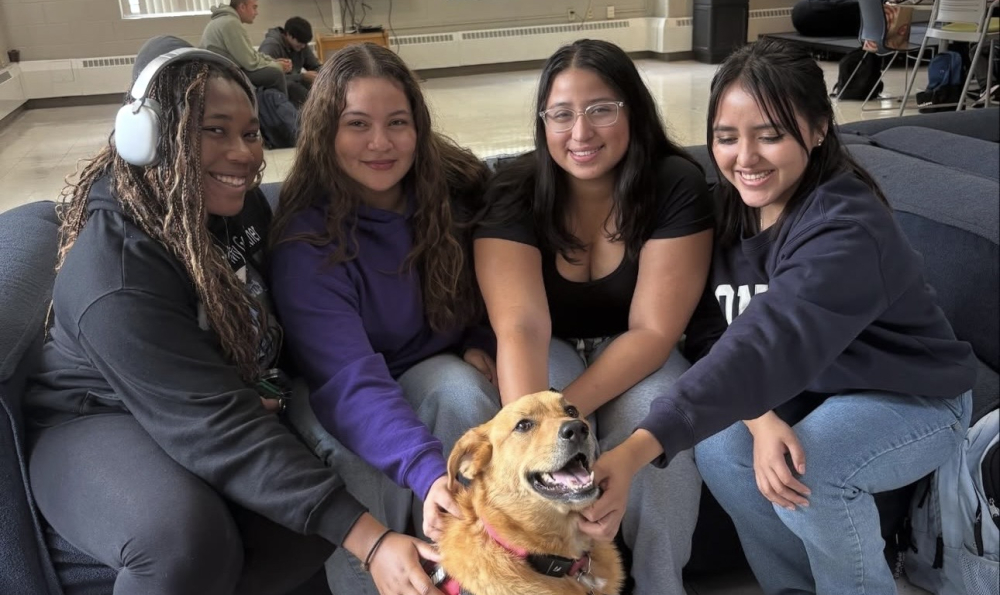 Staff of panther community care center with a dog