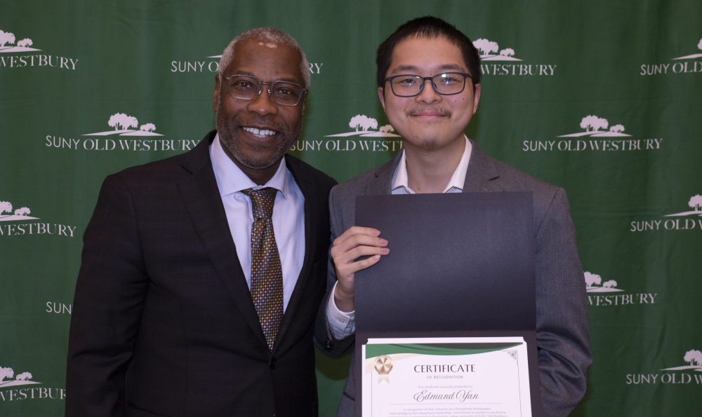 Student Edmund Yan posing with President Sams