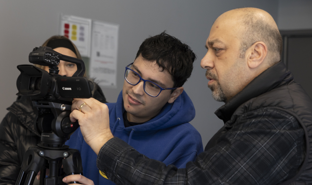 Student and professor Oz looking at the camera at television production class