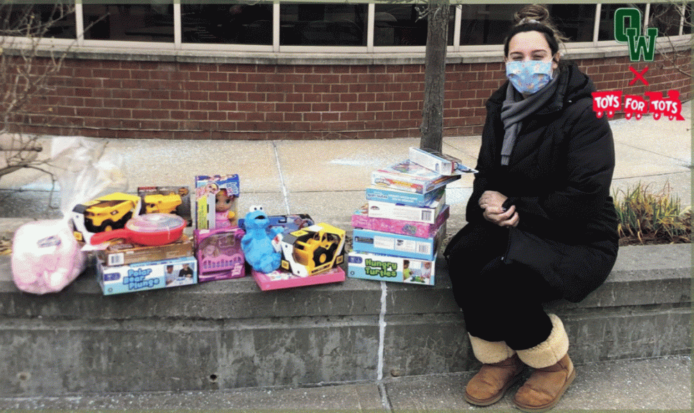Female student-athlete with pile of unwrapped gifts