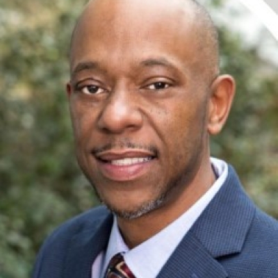 Jermaine Archer in blue suit with red tie