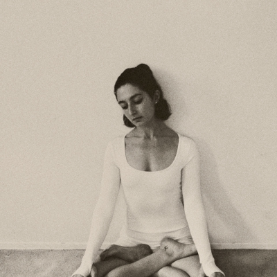 Georgina Berbari seated in a crossed leg yogo pose