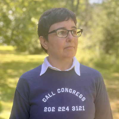Carylyn Cocca wearing navy sweatshirt with text call congress 202 224 3121